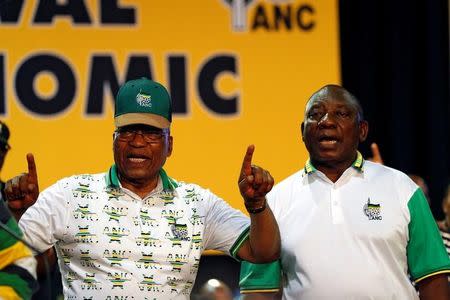 South Africa's President Jacob Zuma sings next to newly elected president of the ANC Cyril Ramaphosa during the 54th National Conference of the ruling African National Congress (ANC) at the Nasrec Expo Centre in Johannesburg, South Africa December 18, 2017. REUTERS/Siphiwe Sibeko/Files