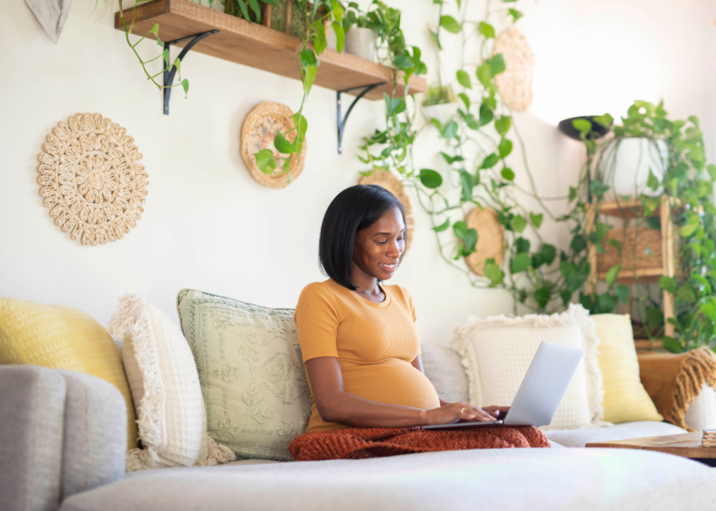 pregnant person looking at computer screen 