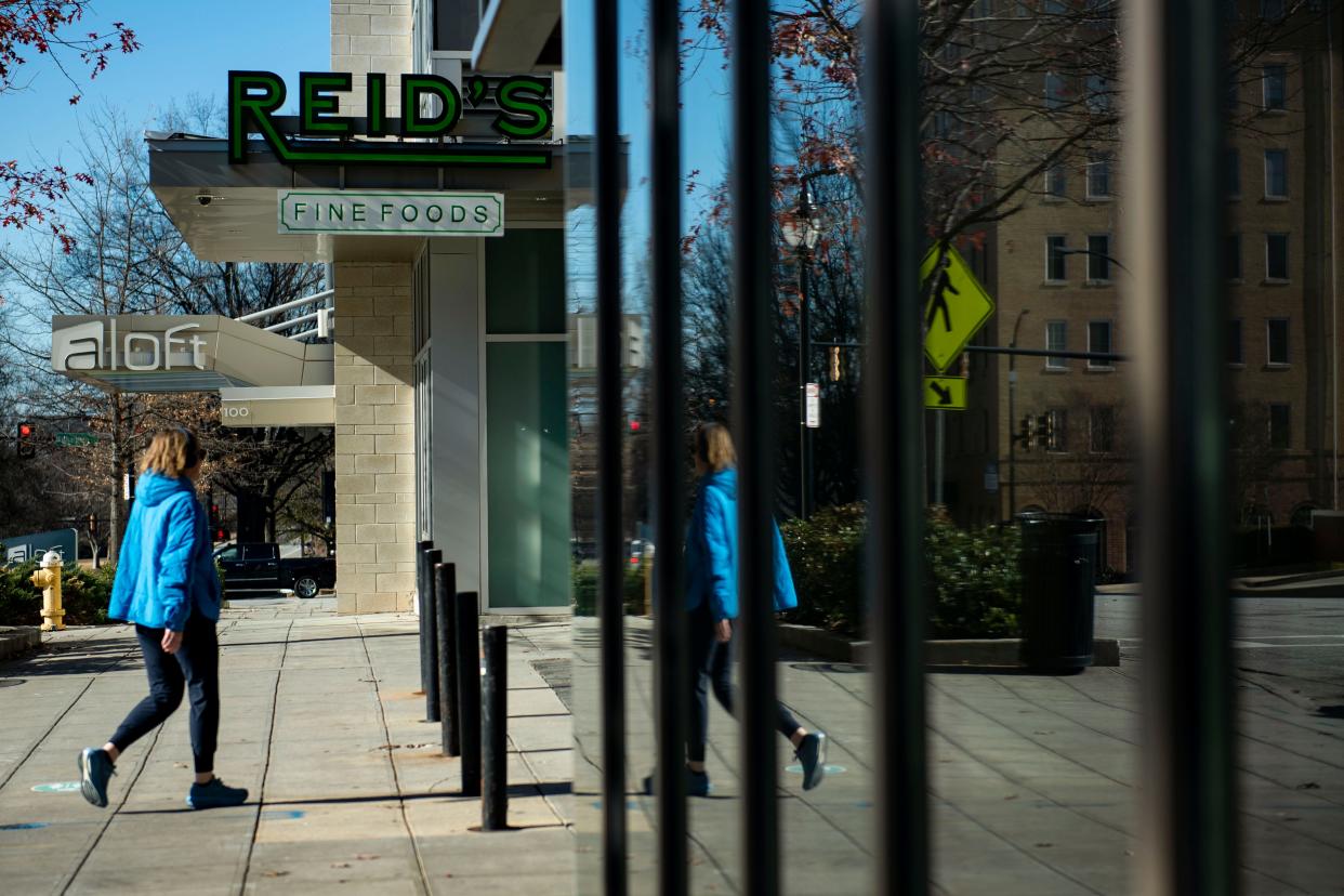 A woman passes by Reid's Fine Foods on Thursday, Jan. 4, 2023.