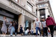 FILE PHOTO: People walk outside the Marks&Spencer shop amid the outbreak of the coronavirus disease (COVID-19), in Oxford Street