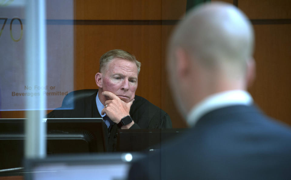 Pierce County Superior Court Judge Michael Schwartz listens to attorney statements during the arraignment appearances for three Tacoma police officers charged in the death of Manuel Ellis, Friday, May 28, 2021 in Tacoma, Wash. Three Washington state police officers pleaded not guilty Friday in the death of Manuel Ellis, another Black man who pleaded for breath under an officer's knee. (Tony Overman/The News Tribune via AP, Pool)