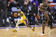 Los Angeles Lakers guard Dennis Schroder (17) sprints downcourt after a steal against Sacramento Kings forward Harrison Barnes (40) during the first quarter of an NBA basketball game in Sacramento, Calif., Friday, April 2, 2021. (AP Photo/Hector Amezcua)