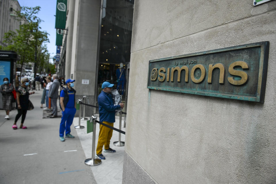 Many customers wait outside the Simons store on Sainte-Catherine Street in Montreal, Quebec on May 25, 2020. - In Montreal, epicenter of the virus in Canada, there is a  reopening of non-essential businesses after a two-month lockdown. (Photo by Sebastien St-Jean / AFP) (Photo by SEBASTIEN ST-JEAN/AFP via Getty Images)