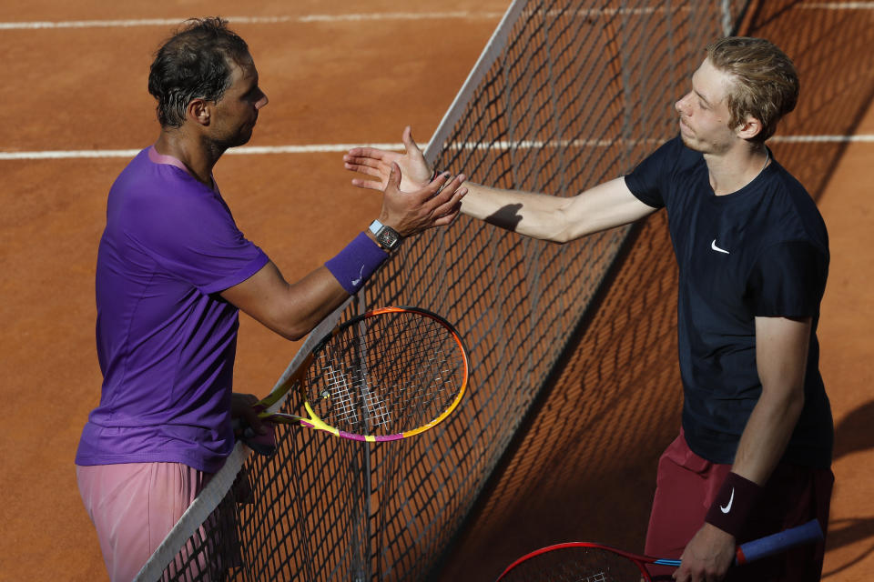 Spain's Rafael Nadal, left, shakes hands with Canada's Denis Shapovalov,at the end of their 3rd round match at the Italian Open tennis tournament, in Rome, Thursday, May 13, 2021. Nadal won 6-3, 4-6, 6-7. (AP Photo/Alessandra Tarantino)