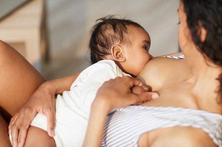 Close up of young mother breastfeeding her baby