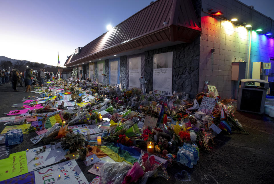 FILE - Mourners gather outside Club Q to visit a memorial on Nov. 25, 2022, in Colorado Spring, Colo. Lawmakers in Colorado and other states are proposing bills to roll back legal protections for gun manufactures and dealers. A draft version of Colorado’s bill, expected to be introduced Thursday, Feb. 23, 2023 would make it easier for Colorado residents to sue gun manufacturers and lays out a code of conduct for the industry partly targeting how companies design and market firearms. (Parker Seibold/The Gazette via AP, File)