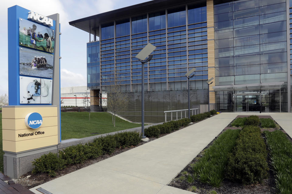 FILE - This is an April 25, 2018, file photo, showing NCAA headquarters in Indianapolis. The NCAA Board of Governors took the first step Tuesday, Oct. 29, 2019, toward allowing athletes to cash in on their fame, voting unanimously to clear the way for the amateur athletes to "benefit from the use of their name, image and likeness." The United States' largest governing body for college athletics realized that it "must embrace change to provide the best possible experience for college athletes," the board said in a news release issued after the vote at Emory University in Atlanta. (AP Photo/Darron Cummings, File)