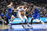 Los Angeles Clippers guard Russell Westbrook, center, goes to the basket between Orlando Magic guard Cole Anthony, left, and forward Jonathan Isaac (1) during the second half of an NBA basketball game, Friday, March 29, 2024, in Orlando, Fla. (AP Photo/John Raoux)