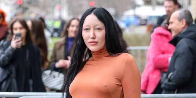 Noah Cyrus Goes Braless and Browless in an Orange Floor-Length Gown 🧡