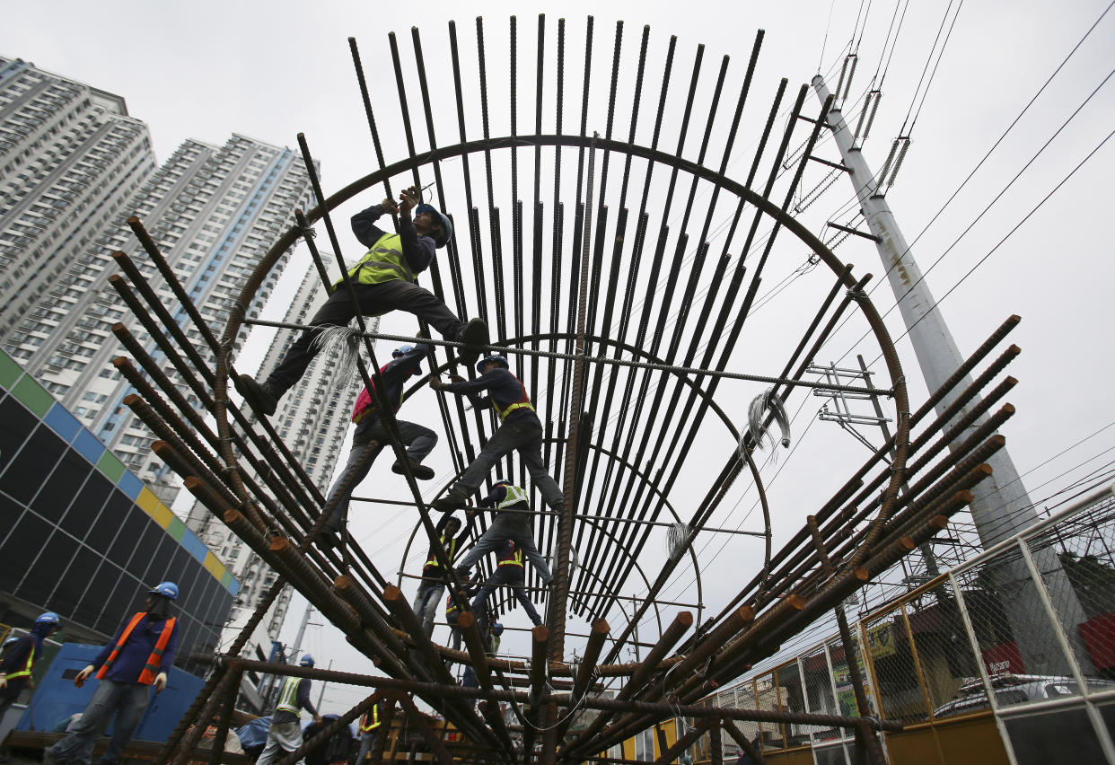 File Photo: In this Wednesday, Aug. 12, 2015 photo, Filipino workers arrange metal rods at a government road project in suburban Quezon City, north of Manila, Philippines. (AP Photo/Aaron Favila)