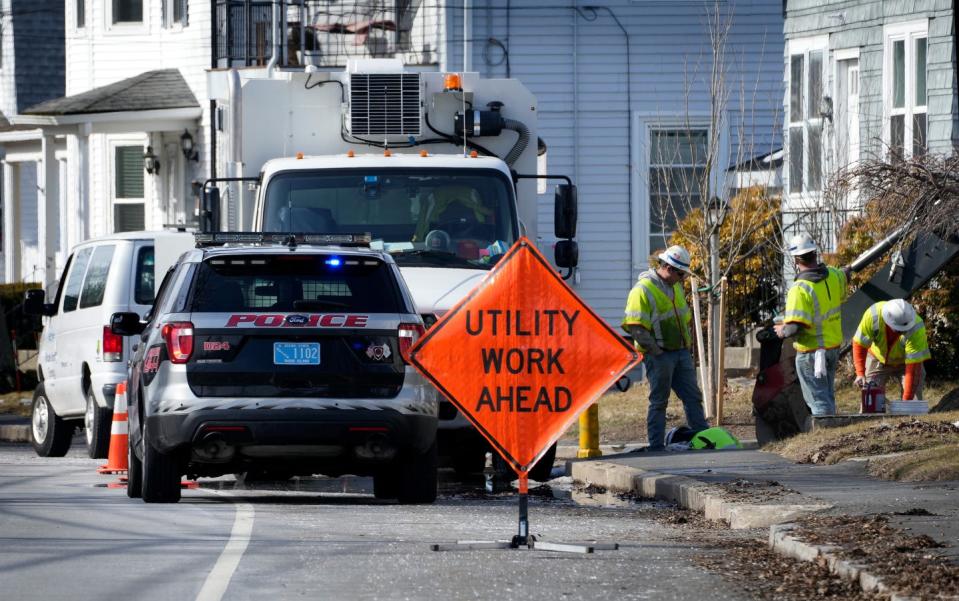 An East Providence police detail oversees work along Centre Street and Carrie Avenue in Rumford.