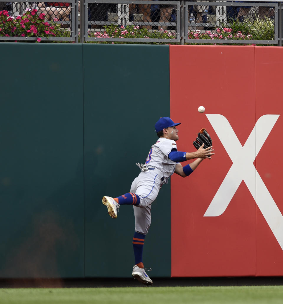 New York Mets' Michael Conforto (30) tries to make a play on a double hit by Philadelphia Phillies' Maikel Franco (7) in the second inning of a baseball game, Saturday, Aug. 18, 2018, in Philadelphia. (AP Photo/Michael Perez)