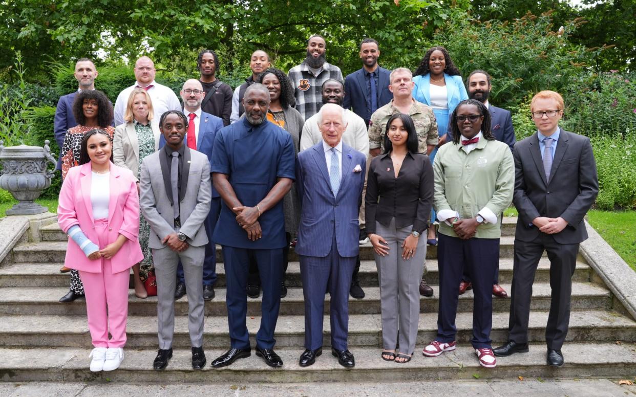 King Charles III (centre) with Idris Elba (centre left) and young people attend an event for The King's Trust to discuss youth opportunity, at St James's Palace