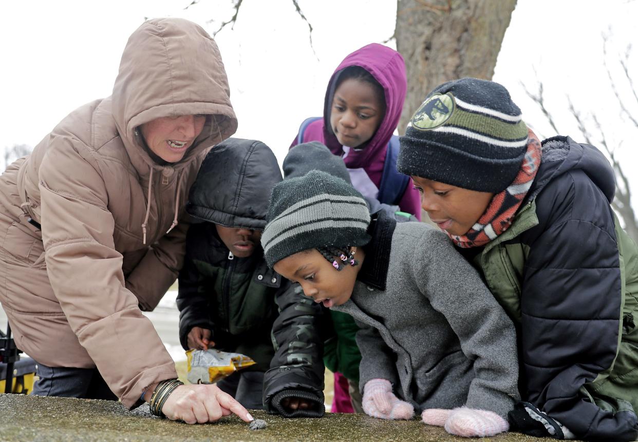 Dean of Students Cathy Porter points out an owl pellet while walking students home after class at Jefferson Elementary School on Thursday, February 9 in Appleton.
