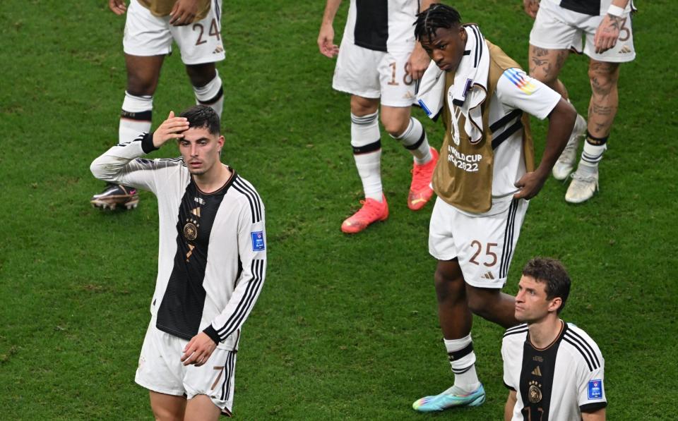 The German players react having been told their 4-1 win over Costa Rica was in vain - Tanaka's winner having ultimately sent them out - Getty Images/Ercin Erturk 