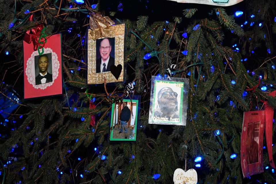 Families place ornaments on a Christmas tree to honor the victims of homicide during the 28th annual Season to Remember Memorial Service at Centennial Art Center in Nashville, Tenn., Thursday, Dec. 8, 2022. 