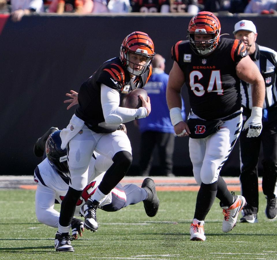 Cincinnati Bengals quarterback Joe Burrow (9) tries to break free from the Houston Texans defense at Paycor Stadium Sunday, November 12, 2023. The Bengals lost 27-30.