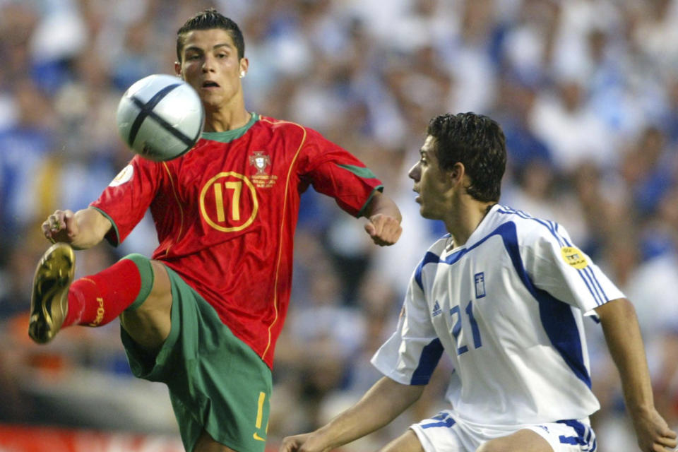 FILE - Portugal's Cristiano Ronaldo, left, controls the ball as Greece's Kostantinos Katsouranis looks on during the Euro 2004 soccer championship final match between Portugal and Greece at the Luz stadium in Lisbon, Portugal, Sunday, July 4, 2004. Portugal's Cristiano Ronaldo and Croatia's Modric go to Euro 2024 showing age is no boundary for soccer's modern stars. (AP Photo/Frank Augstein, File)