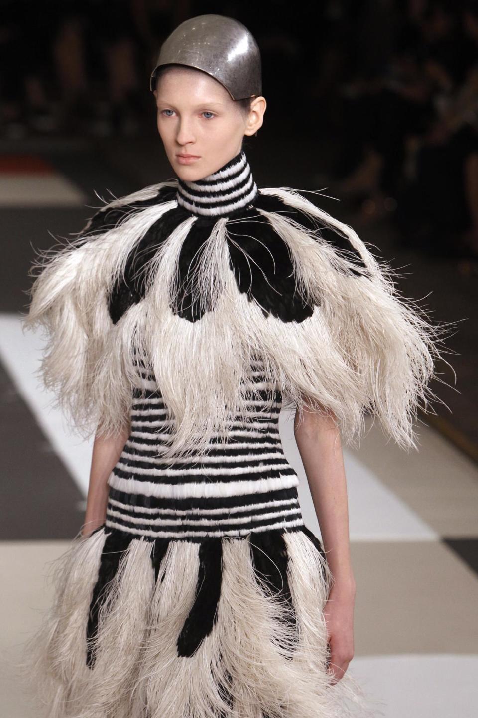 A model presents a creation as part of Alexander McQueen's ready-to-wear Spring/Summer 2014 fashion collection, presented Tuesday, Oct. 1, 2013 in Paris. (AP Photo/Thibault Camus)