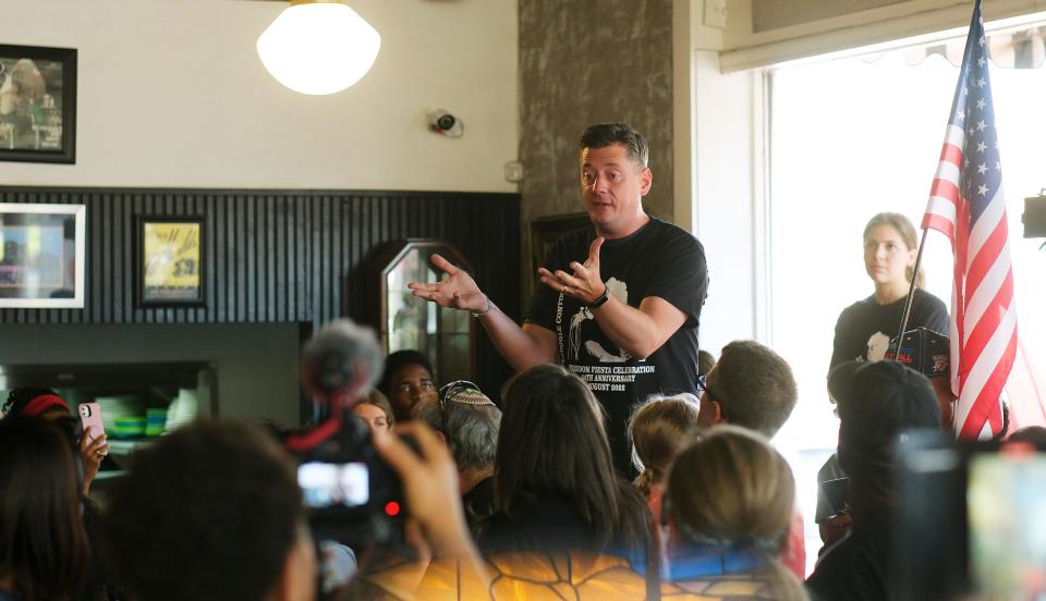 Oklahoma City Mayor David Holt addresses a crowd at Kaiser's Grateful Bean Café during a reenactment of the historic Oklahoma City NAACP Youth Council sit-in demonstration against Jim Crow era segregation.