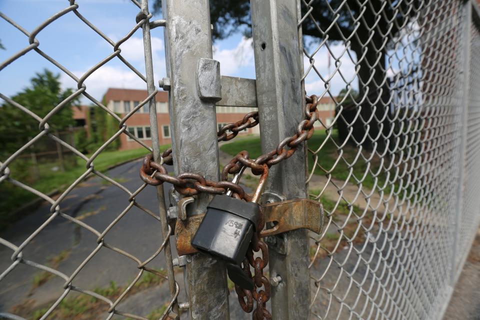 A padlock rest on a gate at the former 142-acre Fisker Automotive plant, formerly know as the Boxwood plant near Newport.