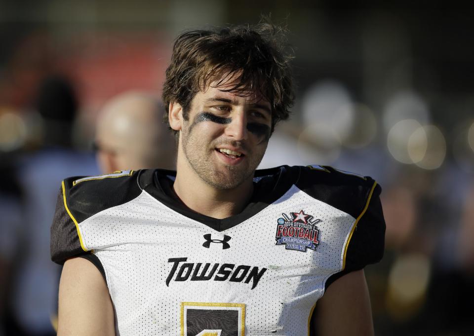 Towson quarterback Peter Athens (7) walks along the bench talking with teammates late in the second half of the FCS championship NCAA college football game against North Dakota State, Saturday, Jan. 4, 2014, in Frisco, Texas. NDSU won 35-7. (AP Photo/Tony Gutierrez)