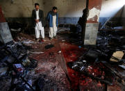 <p>Afghan men inspect at the site of a suicide attack in Kabul, Afghanistan, Dec. 28, 2017. (Photo: Omar Sobhani/Reuters) </p>