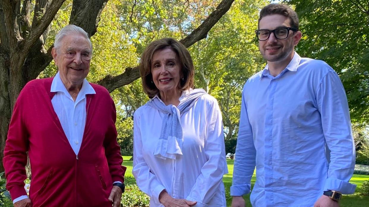 Then-House Speaker Nancy Pelosi of California poses with liberal billionaire donor George Soros, pictured on the left, and his son, Alexander, pictured on the right.