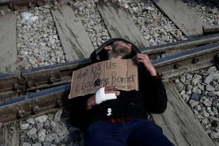 A Syrian refugee protests on railway tracks demanding the opening of the borders, at a makeshift camp at the Greek-Macedonian border near the village of Idomeni, Greece, March 18, 2016. REUTERS/Alkis Konstantinidis