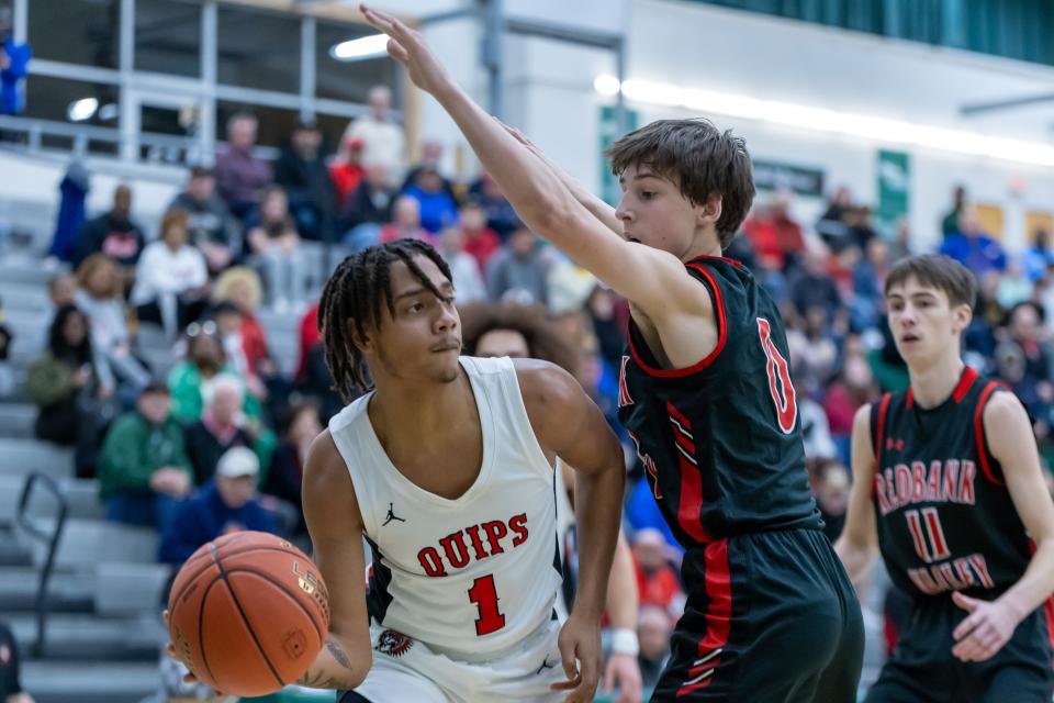 Brandon Banks (1) passes the ball on the baseline while being guarded by Redbank Valley's Breckin Minich (0) during Aliquippa's PIAA quarterfinal matchup against Redbank Valley Saturday afternoon at Morrow Field House.