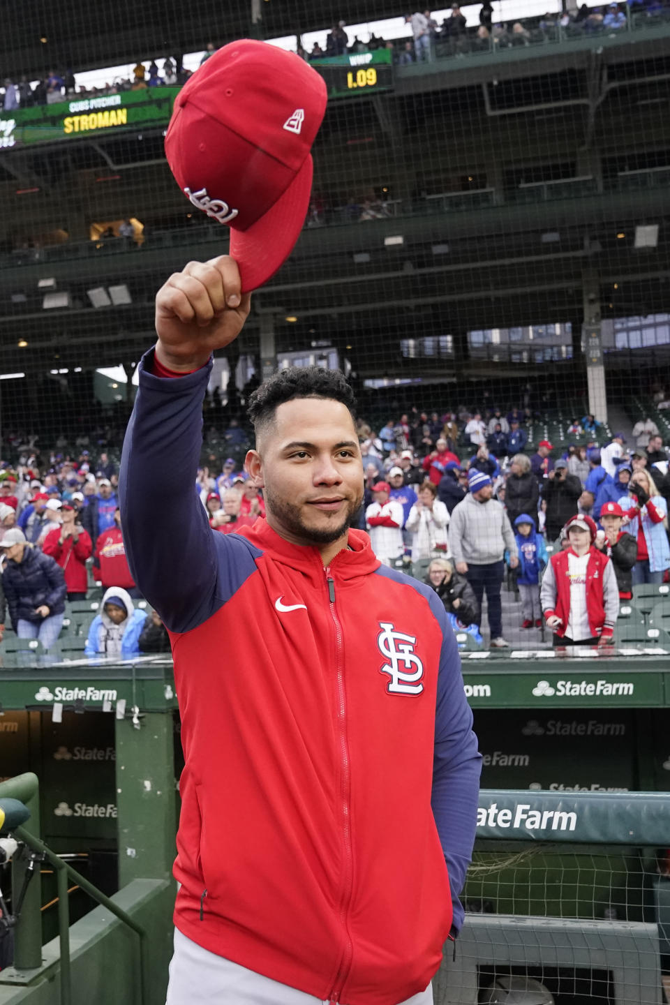 St. Louis Cardinals' Willson Contreras acknowledges the crowd's applause as the Chicago Cubs pay tribute to him before a baseball game Monday, May 8, 2023, in Chicago. Contreras returned to Wrigley Field for the first time since leaving the Cubs after last season. (AP Photo/Charles Rex Arbogast)