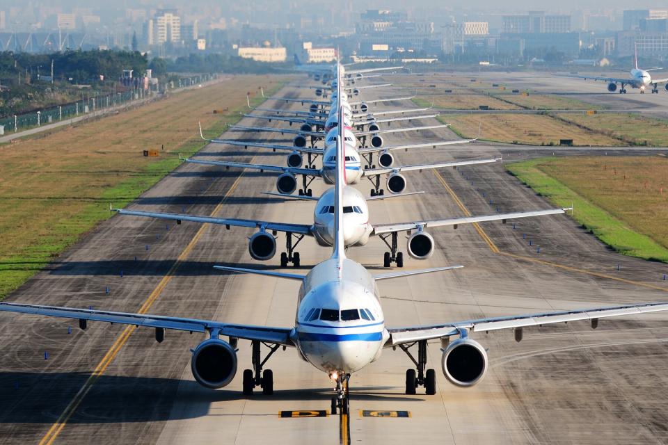 so many airplanes are in line on the runway waiting for take off