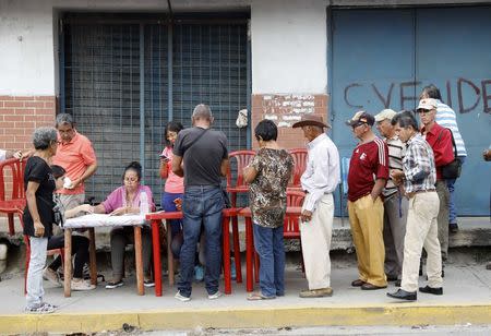 Venezuelan citizens check in at a "Red Point," an area set up by President Nicolas Maduro's party, to verify that they cast their votes during the presidential election in Barquisimeto, Venezuela, May 20, 2018. REUTERS/Carlos Jasso