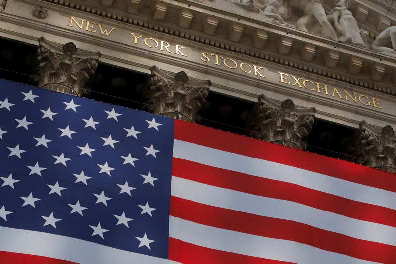 FILE PHOTO: The U.S. flag is seen outside of the New York Stock Exchange (NYSE) in New York City