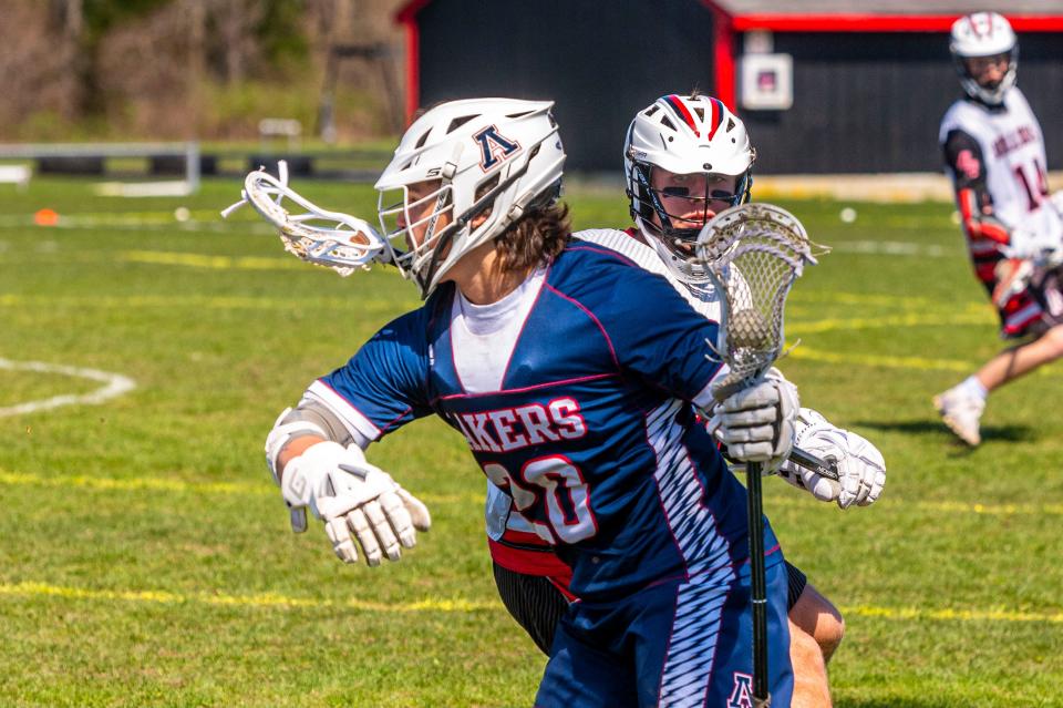 Apponequet's Vinnny Olivieri shields the ball from the Old Rochster defender, as Olivieri looks at his options.