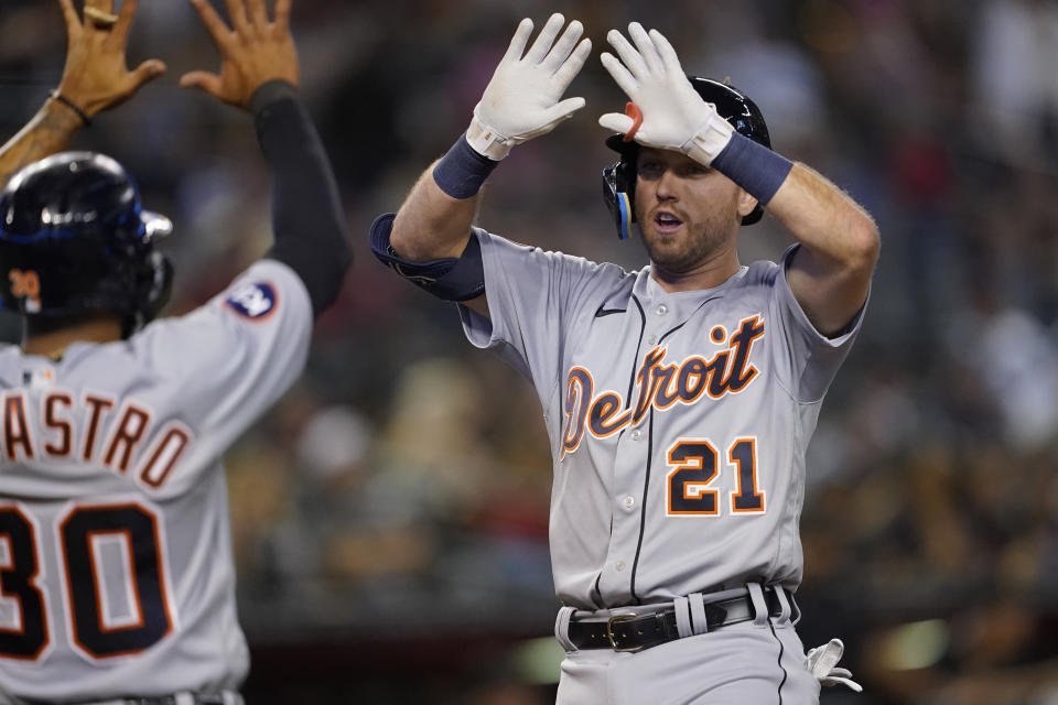 Detroit Tigers' Kody Clemens (21) high fives Harold Castro (30) after hitting a three-run home run against the Arizona Diamondbacks during the sixth inning of a baseball game, Saturday, June 25, 2022, in Phoenix. (AP Photo/Matt York)