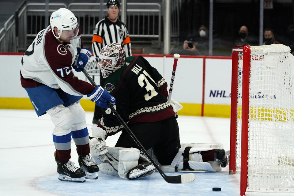 Colorado Avalanche right wing Joonas Donskoi (72) scores on Arizona Coyotes goaltender Adin Hill (31) during the shootout in an NHL hockey game Tuesday, March 23, 2021, in Glendale, Ariz. Arizona won 5-4. (AP Photo/Rick Scuteri)