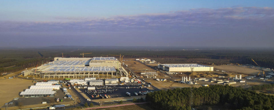 FILE - In this Dec. 8, 2020 file photo, felled trees lie on the construction site of the Tesla Gigafactory in Gruenheide near Berlin, Germany. A German court has ruled that automaker Tesla Inc. has to stop clearing trees on some parts of the site where it’s building its first electric car factory in Europe. (Patrick Pleul/dpa via AP, File)