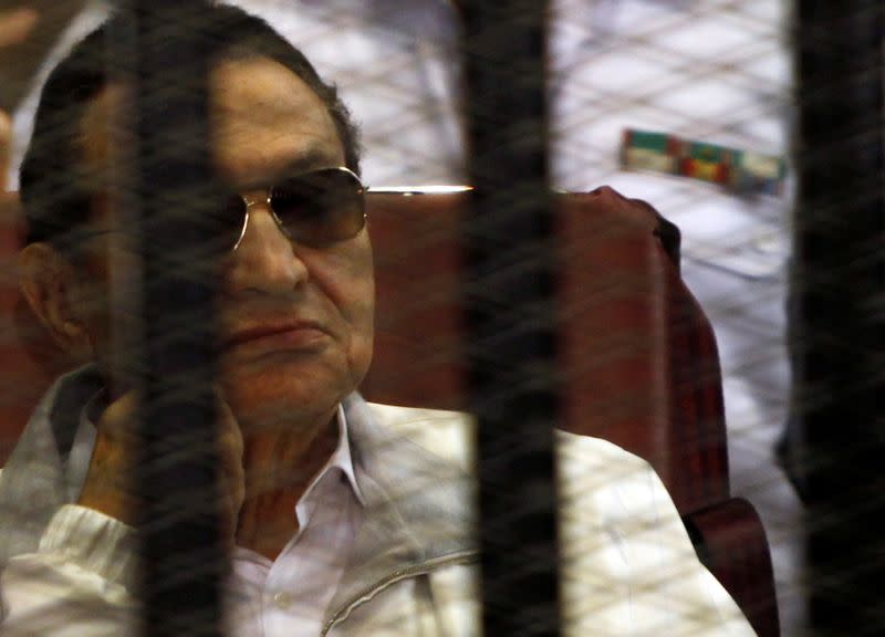 FILE PHOTO: Egypt's ousted President Hosni Mubarak sits inside a dock at the police academy, on the outskirts of Cairo