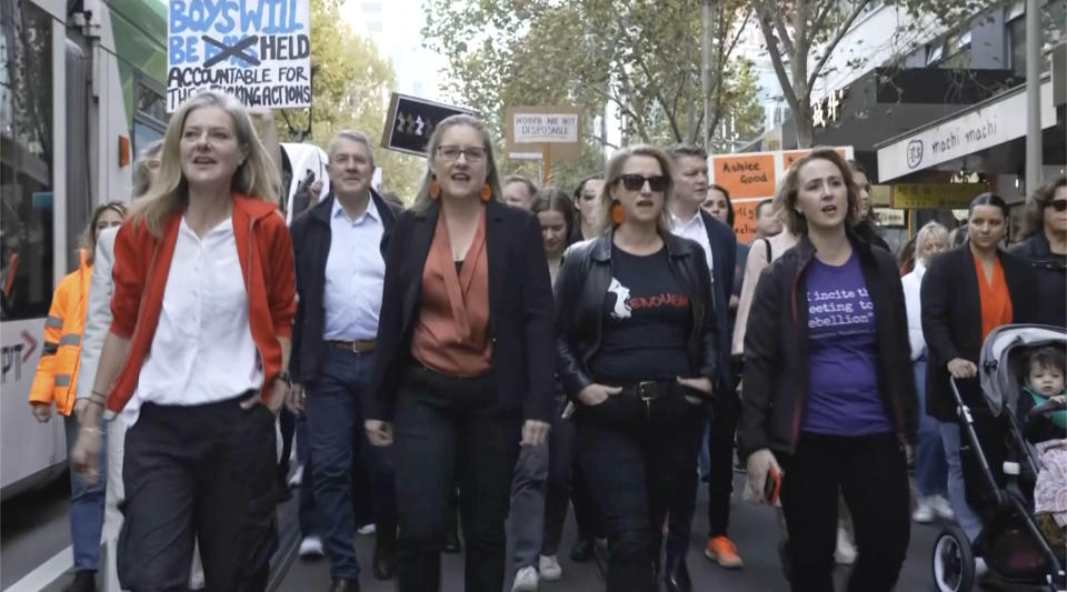 In this image made from video provided by AUBC, people march and shout slogans during a protest against gender-based violence, in Melbourne, Australia, Sunday, April 28, 2024. Thousands of people rallied across Australia on Sunday, demanding action to end gender-based violence in the country. (AUBC via AP)