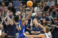 McNeese State guard Javohn Garcia (14) shoots as Gonzaga forward Ben Gregg (33) defends during the first half of a first-round college basketball game in the NCAA Tournament in Salt Lake City, Thursday, March 21, 2024. (AP Photo/Rick Bowmer)