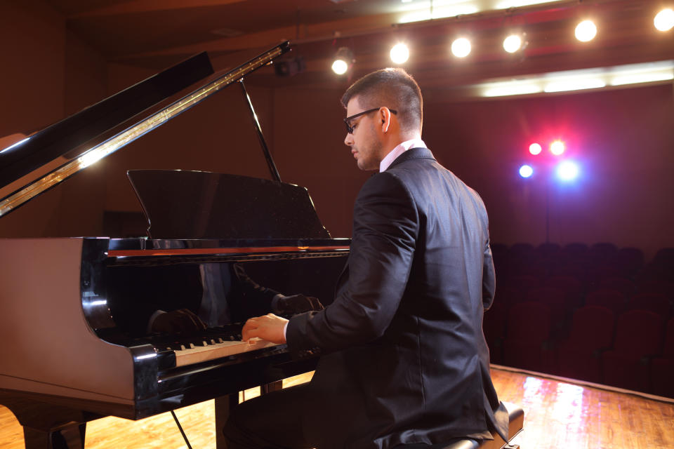 Piano player playing in a concert hall