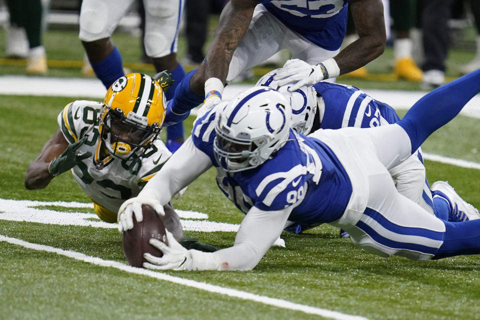 Green Bay Packers' Marquez Valdes-Scantling (83) fumbles a catch during the overtime of an NFL football game against the Indianapolis Colts, Sunday, Nov. 22, 2020, in Indianapolis. Colts' DeForest Buckner (99) recovered the fumble. (AP Photo/Michael Conroy)