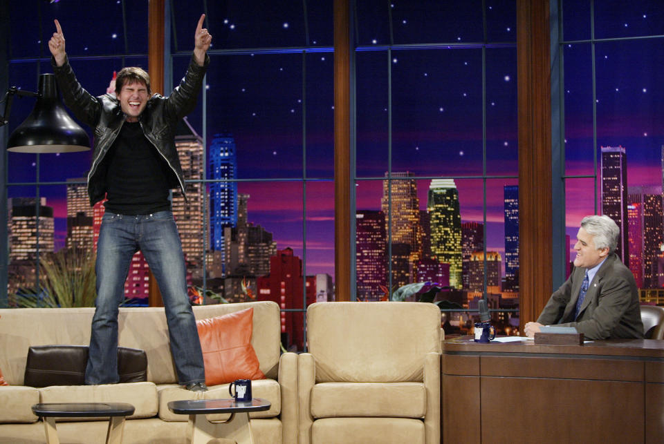 Tom Cruise stands on a couch, something he likes to do, during an interview on "The Tonight Show with Jay Leno" in 2005. (Photo: NBC via Getty Images)