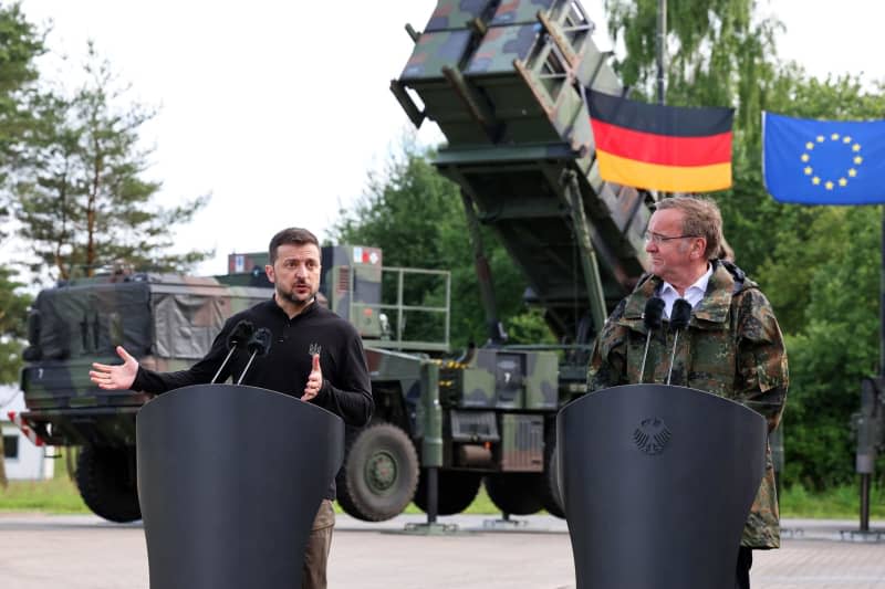 German Minister of Defense Boris Pistorius and Ukrainian President Volodymyr Zelensky hold a joint press conference during their visit to a military training area to learn about the training of Ukrainian soldiers on the "Patriot" anti-aircraft missile system. Jens Büttner/dpa