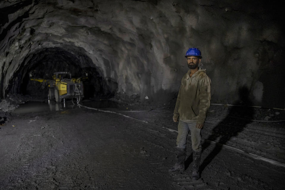 Tariq Ahmed Lone, a Kashmir worker employed by the Megha Engineering And Infrastructures Limited (MEIL) poses for picture as he works inside the Nilgrar Tunnel in Baltal area, northeast of Srinagar, Indian controlled Kashmir, Tuesday, Sept. 28, 2021. High in a rocky Himalayan mountain range, hundreds of people are working on an ambitious project to drill tunnels and construct bridges to connect the Kashmir Valley with Ladakh, a cold-desert region isolated half the year because of massive snowfall. The $932 million project’s last tunnel, about 14 kilometers (9 miles) long, will bypass the challenging Zojila pass and connect Sonamarg with Ladakh. Officials say it will be India’s longest and highest tunnel at 11,500 feet (3,485 meters). (AP Photo/Dar Yasin)