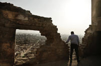 <p>A man looks at the general view of a cemetery from the Shahin Al-Khalwati Mosque in Cairo, Egypt, Aug. 24, 2016. Muslim Sufi Saint Shahin Al-Khalwati built the mosque in the 16th century on top of a hill where he would go into spiritual seclusion. Today the neglected mosque sits on the top of a hill of a cemetery. Al-Khalwati’s grandchildren demand the government restore the mosque because it is a heritage site according to civilians who live in the cemetery area. (Photo: Nariman El-Mofty?AP) </p>