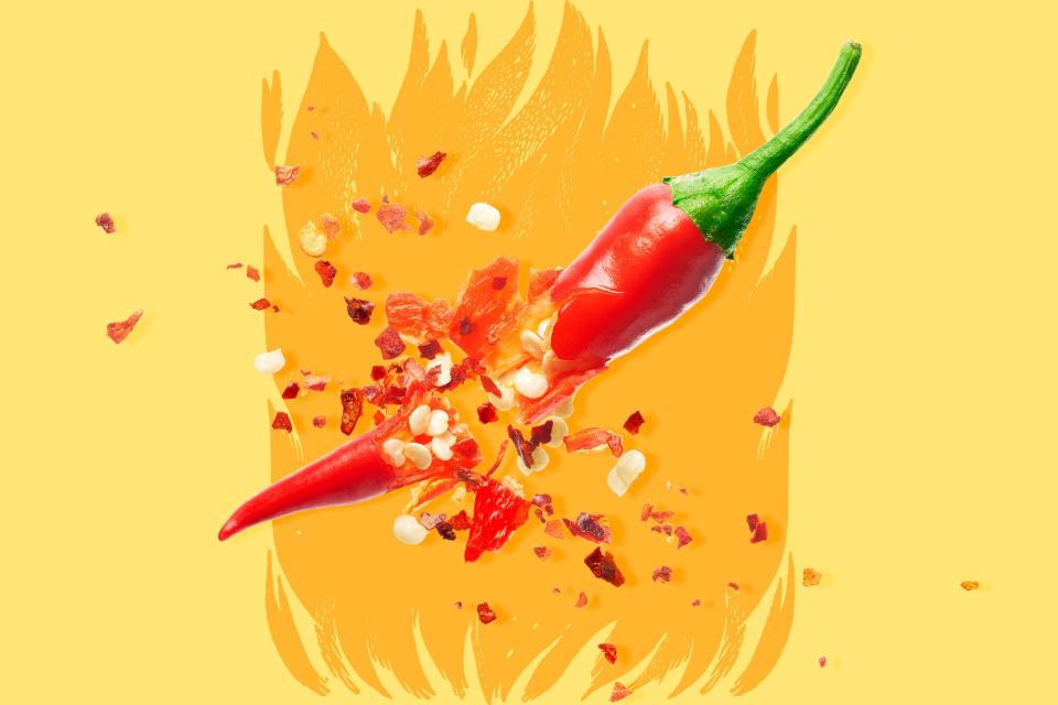 An exploding chili pepper on a designed background