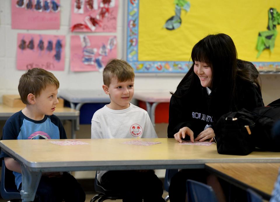 Brantley Wilson, 5, and Vinnie Florea, 5, get to know Koharu Ishiioka, one of a group of Japanese students hosted by Mount Union and staying with host families who visited Union Avenue United Methodist Church Preschool.    Wednesday,  March 29, 2023.