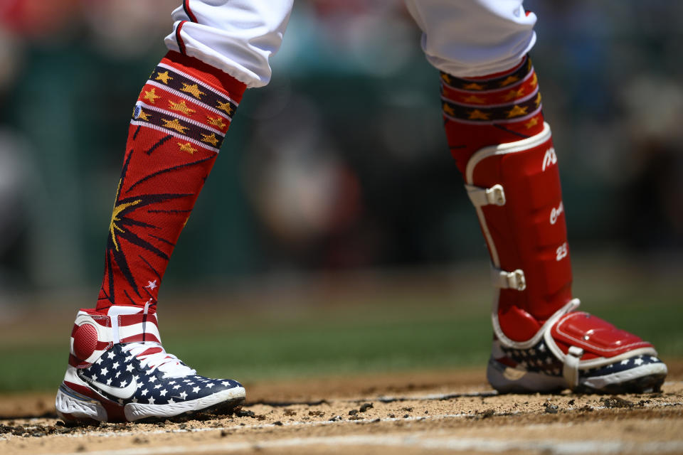Washington Nationals' Nelson Cruz wears patriotic themed shoes during is at bat during the first inning of a baseball game against the Miami Marlins, Monday, July 4, 2022, in Washington. (AP Photo/Nick Wass)
